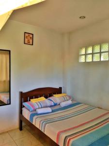 a bedroom with a bed and two windows at D downhill'Place in Oslob