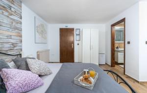 a room with a bed with a tray of food on it at Apartments Ariana in Umag