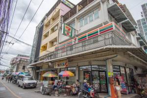 a building with people sitting outside of it on a city street at T4 Two Bedrooms Full kitchen/1 min to BTS in Bangkok