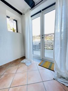 a room with a large window and a tiled floor at aday - Central Charming Apartment with Terrace in Aalborg