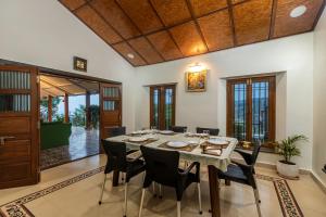 a dining room with a table and chairs at SaffronStays Verandah by the Valley, Panchgani - luxury villa and treehouse with beautiful valley and lake views in Panchgani