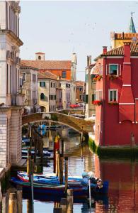 a bridge over a canal with boats in the water at Chioggia House di Marco in Chioggia