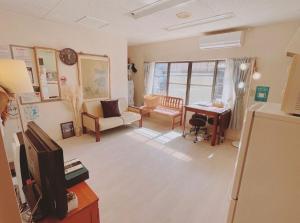 a living room with a couch and a table at Minpaku inn Ise-Shima - Vacation STAY 39102v in Ise