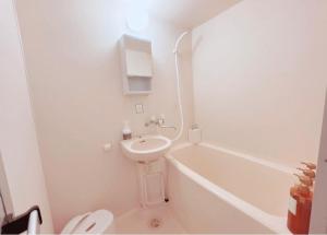 a bathroom with a sink and a toilet and a tub at Minpaku inn Ise-Shima - Vacation STAY 39102v in Ise