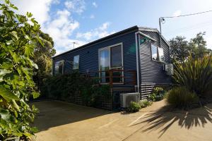 a blue tiny house sitting in a driveway at 19 Blue in Kingston Beach