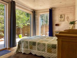 a bedroom with a bed and a large window at Kakupesa Puhkemaja in Hara