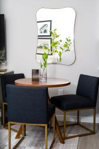 a dining room table with two chairs and a mirror at Luxury Apartments by Hyatus at Pierpont in New Haven +82 photos