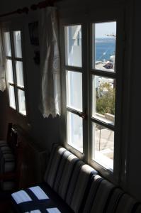 a room with a window with a view of the ocean at Panormos Villa Tinos Greece - Traditional House in Pánormos