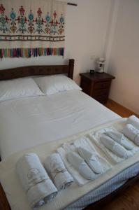 a bed with three towels sitting on it at Panormos Villa Tinos Greece - Traditional House in Pánormos