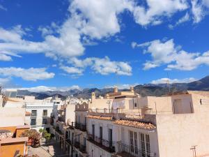 a view of a city with mountains in the background at Estudio lola in Nerja