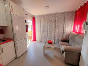 a living room with a couch and a table at Estudio lola in Nerja
