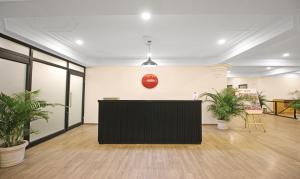 an office with a large black podium in a room with potted plants at Treebo Trend Grand Legacy Shahenshah in Dehradun