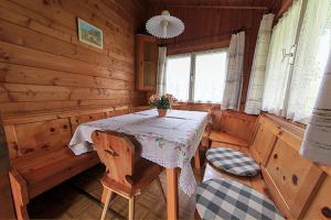 a dining room with a table and chairs in a cabin at Aussersalfner Hütte in Schenna