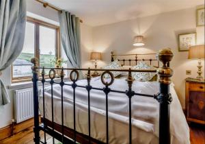 a bedroom with a bed and a window at Red Lion House in Hartington