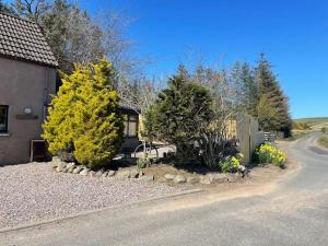 a house with trees and a road next to a house at The Steading with 7 Seater Hot Tub Aberdeenshire in Banff
