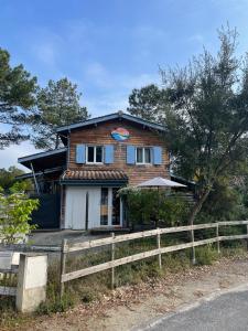 a house with a fence in front of it at Le Petit Havre in Lacanau-Océan