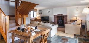 a living room with a couch and a table at Downe Cottages in Hartland
