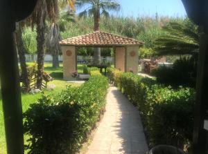 a garden with a gazebo and a path at Villa al Bastione di Malta in SantʼEufemia Lamezia