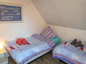 two beds in a small room with at Holiday Home Tossens-3 by Interhome in Butjadingen OT Tossens