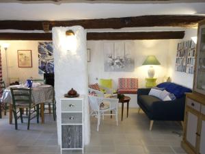 a living room with a couch and a table at Holiday Home Les Vignes by Interhome in Saint-Côme