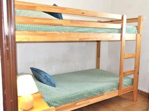 a bunk bed in a room with a desk and a lamp at Apartment Les Maisons de la Plage-3 by Interhome in Narbonne-Plage