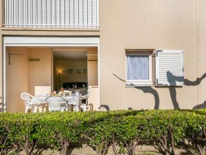 a table and chairs on the balcony of a house at Apartment Les Sables d'Or-8 by Interhome in Le Grau-du-Roi