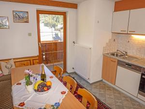 a kitchen with a table with a bowl of fruit on it at Apartment Alpenhof-1 by Interhome in Sinsen