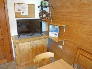 a room with a counter with a television and a table at Apartment Alpenhof-1 by Interhome in Sinsen +42 photos