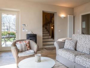 Una sala de estar con un sofá y sillas y una mesa. en Holiday Home Cascina-1 by Interhome, en Costigliole dʼAsti