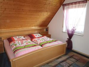 a bed sitting in a room with a window at Apartment Villa Sorgenfrei by Interhome in Ovelgönne