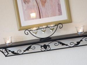 a shelf with candles and a picture on a wall at Apartment Panorama by Interhome in Berghofen