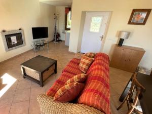 a living room with a couch and a tv at Holiday Home Monte Tabor by Interhome in Carmine
