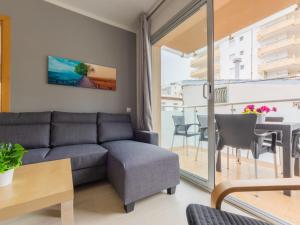 a living room with a couch and a table at Apartment Terecel Salou-1 by Interhome in Salou