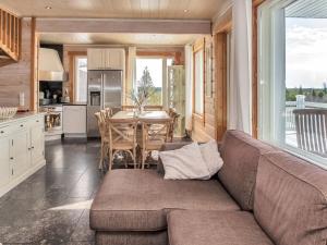 a living room with a couch and a kitchen with a table at Holiday Home Saaruan aurinko by Interhome in Ruka