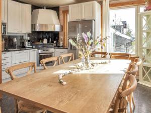 a kitchen with a wooden table with a vase of flowers on it at Holiday Home Saaruan aurinko by Interhome in Ruka