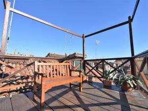 a wooden bench sitting on top of a balcony at Apartment Fondamenta del Rielo by Interhome in Venice