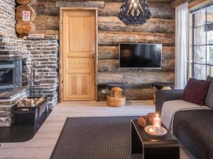 a living room with a couch and a fireplace at Holiday Home Harjula by Interhome in Nissi