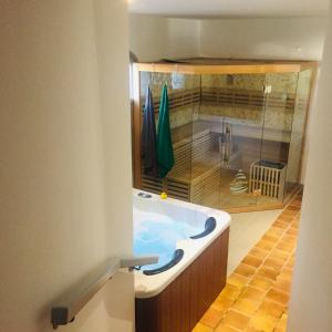 a bathroom with a large tub in a room at Maison d'hôtes naturiste Villa PaulAna in Cap d'Agde
