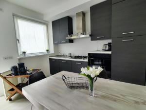 eine Küche mit einem Tisch und einer Blumenvase darauf in der Unterkunft Apartment Titti - GLA133 by Interhome in Gera Lario
