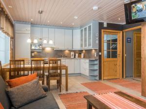 a kitchen and dining room with a table and chairs at Holiday Home Pyrykieppi by Interhome in Sonka