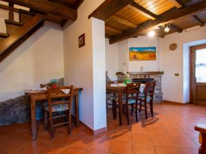 a dining room with wooden tables and chairs at Holiday Home Paradiso I by Interhome in Bolognana +28 photos