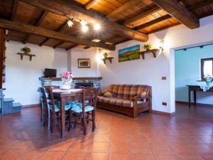 a living room with a table and a couch at Holiday Home Paradiso II by Interhome in Bolognana