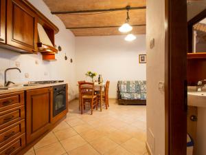 a kitchen with a table and a dining room at Apartment Archi - CET121 by Interhome in Luia
