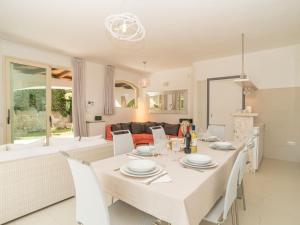 a dining room and living room with a table and chairs at Villa La Dolce Vita by Interhome in Buoncammino