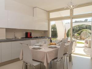 a kitchen and dining room with a table and chairs at Villa La Dolce Vita by Interhome in Buoncammino