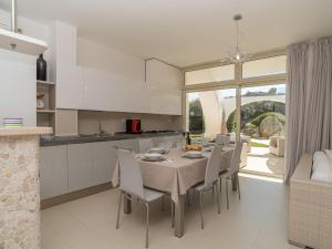 a kitchen and dining room with a table and chairs at Villa La Dolce Vita by Interhome in Buoncammino +38 photos