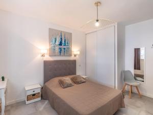 a bedroom with a bed and a desk and a chair at Holiday Home Polpu by Interhome in Sari Solenzara