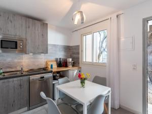 a small kitchen with a white table and chairs at Holiday Home Signoria by Interhome in Sari Solenzara