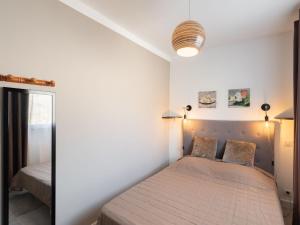 a bedroom with a bed and a mirror at Holiday Home Signoria by Interhome in Sari Solenzara +10 photos