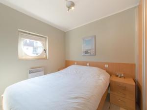 a bedroom with a white bed and a window at Apartment Estepona by Interhome in Mispelburg